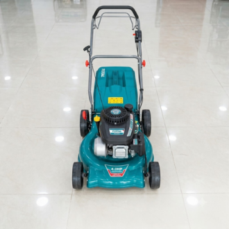 A teal Total 4.0HP gasoline-powered lawn mower positioned centrally on a glossy tiled floor.