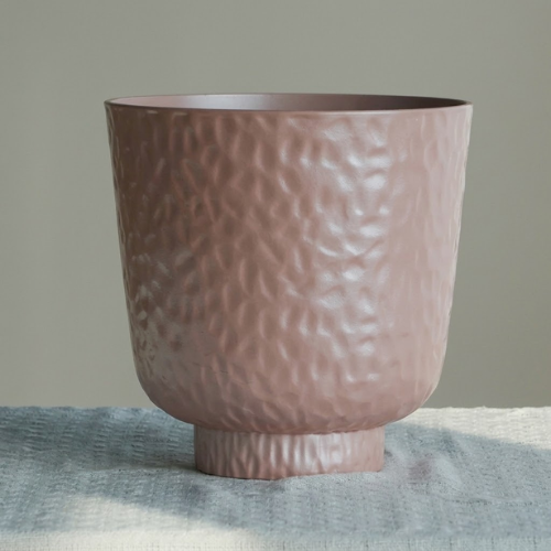 dusty-pink-textured-planter-pot-with-tray Dusty pink textured planter pot with tray resting on a tabletop
