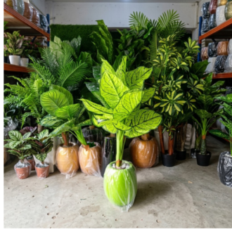 Vibrant artificial tropical plant paired with a bright lime green planter set in Lagos