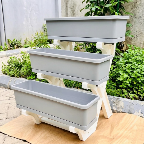 Untitled design (98) 3-tier multi layer planter with grey rectangular troughs on a white frame setup outdoors